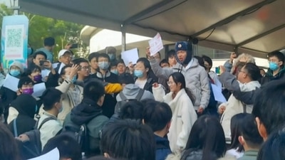 Students protesting by using ‘blank sheets’ against China's zero-Covid policy at Tsinghua University in Beijing on Sunday. (AFP) 