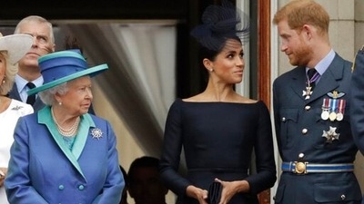 Queen Elizabeth II with Prince Harry and Meghan Markle in old photo. (AP) Queen Elizabeth II with Prince Harry and Meghan Markle in old photo. (AP)