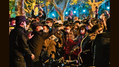 Protesters clash with police in Shanghai on Sunday. (AFP) Protesters clash with police in Shanghai on Sunday. (AFP)
