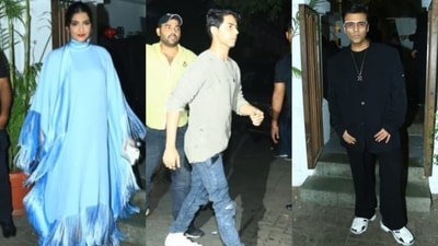 Karan Johar, Aryan Khan and Sonam Kapoor pose for the paparazzi outside the restaurant. (HT Photo)