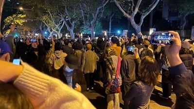 China sees new record surge, hit by anti-Covid protests