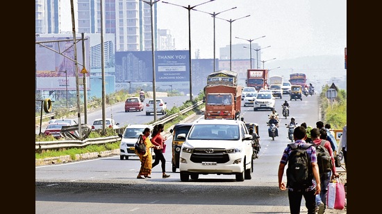 Pedestrians crossing the road at Navale Bridge. (HT FILE PHOTO)