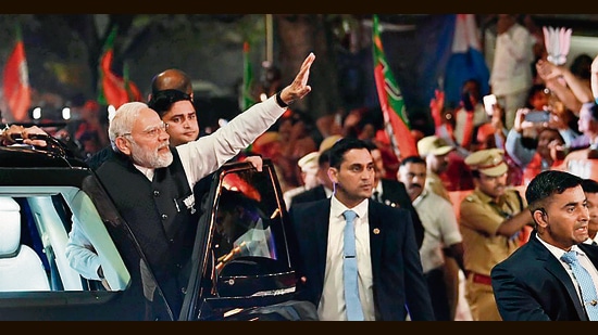 Prime Minister Narendra Modi during a roadshow in Surat on Sunday. (ANI)