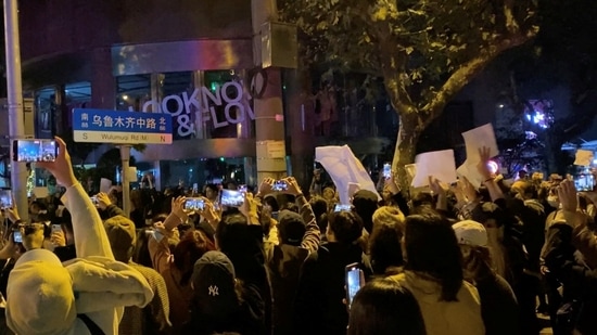 Protesters raise blank sheets of white paper as a symbol of dissent against China's strict Covid lockdown rules. (via REUTERS)