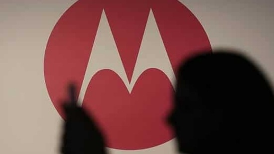 A woman takes a picture in front of a Motorola logo before the worldwide presentation of the Moto G mobile phone in Sao Paulo. (Photo:Reuters/Nacho Doce)