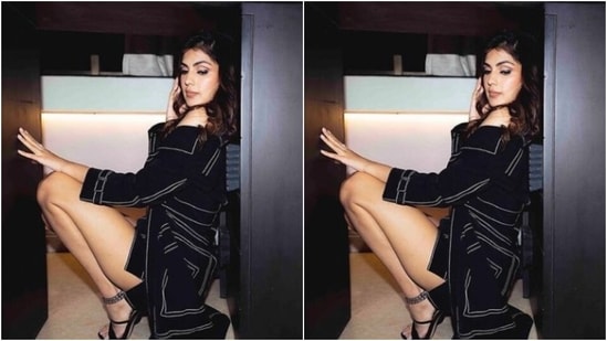 Rhea decked up in a black corset cropped top with white details, and teamed it with a black cropped jacket and folded sleeves. She layered her look with a black short skirt with white lines running at the borders.(Instagram/@rhea_chakraborty)