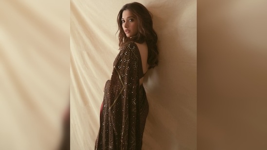 Tamannaah Bhatia ditched dresses and gowns for this elegant 6-yards featuring sequin work spread all over.(Instagram/@stylebyami)