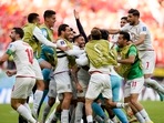 Iran's Rouzbeh Cheshmi, not seen, celebrates scoring the opening goal with teammates during the World Cup group B soccer match between Wales and Iran, at the Ahmad Bin Ali Stadium in Al Rayyan , Qatar.(AP) Iran's Rouzbeh Cheshmi, not seen, celebrates scoring the opening goal with teammates during the World Cup group B soccer match between Wales and Iran, at the Ahmad Bin Ali Stadium in Al Rayyan , Qatar.(AP)