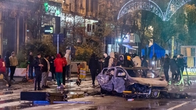 People stand next to a burned out car during riots in Brussels, Sunday, Nov. 27, 2022. Police had to seal off parts of the center of Brussels and moved in with water cannons and tear gas to disperse crowds following violence during and after Morocco's 2-0 win over Belgium at the World Cup. (AP) People stand next to a burned out car during riots in Brussels, Sunday, Nov. 27, 2022. Police had to seal off parts of the center of Brussels and moved in with water cannons and tear gas to disperse crowds following violence during and after Morocco's 2-0 win over Belgium at the World Cup. (AP)