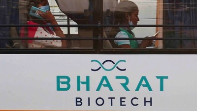 An employee of Bharat Biotech speaks on a mobile phone inside a bus (AP Photo) An employee of Bharat Biotech speaks on a mobile phone inside a bus (AP Photo)