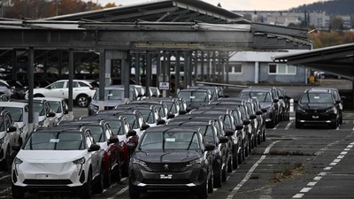 Cars are parked on the Sochaux Stellantis car plant parking in Sochaux, eastern France. (AFP) Cars are parked on the Sochaux Stellantis car plant parking in Sochaux, eastern France. (AFP)