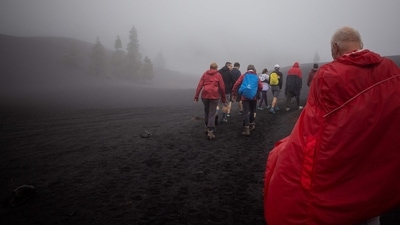 A group of hikers take part in a tour to visit the Tajogaite volcano, previously known as Cumbre Vieja for the ridge on which it sits, in Los Llanos de Aridane, on the Canary Island of La Palma (Photo by Desiree MARTIN / AFP) A group of hikers take part in a tour to visit the Tajogaite volcano, previously known as Cumbre Vieja for the ridge on which it sits, in Los Llanos de Aridane, on the Canary Island of La Palma (Photo by Desiree MARTIN / AFP)