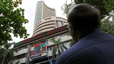 A man looks at a screen across a road displaying the Sensex on the facade of the Bombay Stock Exchange (BSE) building in Mumbai. (REUTERS)