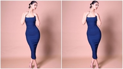 Vaani's ensemble features strappy sleeves, a wide low-cut U neckline, corseted bodice, a bodycon fitting accentuating Vaani's svelte frame, a midi-length hem, zip closure on the back, and backless detail. (Instagram)