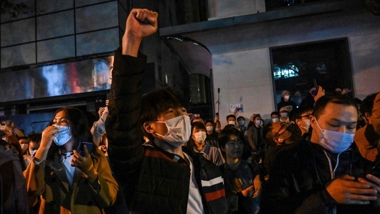 Demonstrators raise slogans on a street in Shanghai on November 27. There were cries heard for the resignation of Xi and the end of the Communist Party that has ruled China for 73 years, which could be deemed as sedition, and is punishable by prison.(Hector Retamal / AFP)