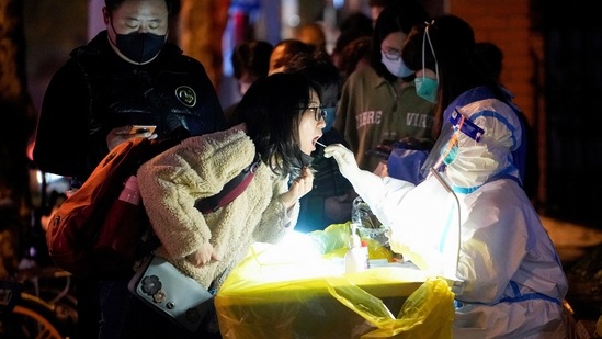 A woman gets tested at a nucleic acid testing site, in Shanghai, on November 28. China's stringent measures were originally accepted for minimizing deaths while other countries suffered devastating waves of infections, but that consensus has begun to fray in recent weeks.(Aly Song / REUTERS)