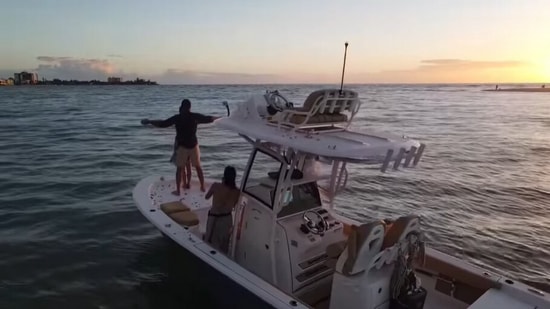 The image, taken from the Facebook video, shows the man and his finance on a boat.(Facebook/@Scott Clyne)