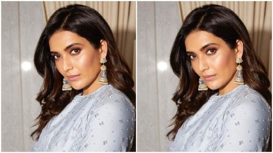 Styled by fashion stylist Shrushti Gupta, Karishma wore her tresses open in wavy curls with a side part.(Instagram/@karishmaktanna)