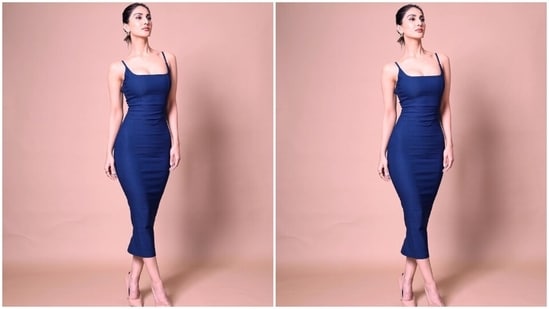 On Sunday night, Vaani Kapoor posted pictures of herself on Instagram with the caption, "Syncing pictures with my mood...unfiltered." The photos show Vaani dressed in a dark blue figure-hugging dress and serving stunning poses for the camera. The ensemble is from the shelves of a British luxe clothing label Vesper.(Instagram)