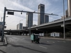 A motorist on a deserted road in the central business district in Beijing, China.