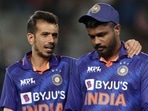 India's Yuzvendra Chahal (L) consoles Sanju Samson after their defeat during the first one-day international cricket match between New Zealand and India at Eden Park in Auckland on November 25, 2022. (Photo by DAVID ROWLAND / AFP) India's Yuzvendra Chahal (L) consoles Sanju Samson after their defeat during the first one-day international cricket match between New Zealand and India at Eden Park in Auckland on November 25, 2022. (Photo by DAVID ROWLAND / AFP)