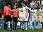 England's forward Harry Kane (R) shakes hands with referees at the end of the Qatar 2022 World Cup Group B football match
