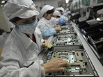 Chinese workers working in the Foxconn factory, the world's largest iPhone factory.(AFP) Chinese workers working in the Foxconn factory, the world's largest iPhone factory.(AFP)