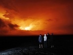 People watch the eruption of Mauna Loa, near Hilo, Hawaii. Mauna Loa, the world's largest active volcano erupted Monday for the first time in 38 years. (AP Photo/Marco Garcia) People watch the eruption of Mauna Loa, near Hilo, Hawaii. Mauna Loa, the world's largest active volcano erupted Monday for the first time in 38 years. (AP Photo/Marco Garcia)