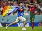 A pitch invader runs across the field with a rainbow flag during the World Cup group H soccer match between Portugal and Uruguay, at the Lusail Stadium in Lusail, Qatar, Monday, Nov. 28, 2022. (AP Photo/Abbie Parr)(AP) A pitch invader runs across the field with a rainbow flag during the World Cup group H soccer match between Portugal and Uruguay, at the Lusail Stadium in Lusail, Qatar, Monday, Nov. 28, 2022. (AP Photo/Abbie Parr)(AP)