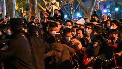 China Covid Protests: Police and people are pictured during some clashes in Shanghai. China Covid Protests: Police and people are pictured during some clashes in Shanghai.