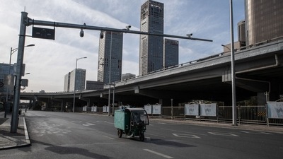 A motorist on a deserted road in the central business district in Beijing, China. (Bloomberg) A motorist on a deserted road in the central business district in Beijing, China. (Bloomberg)