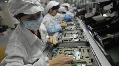 Chinese workers working in the Foxconn factory, the world's largest iPhone factory. (AFP)