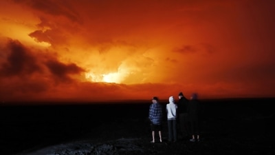 People watch the eruption of Mauna Loa, near Hilo, Hawaii. Mauna Loa, the world's largest active volcano erupted Monday for the first time in 38 years. (AP Photo/Marco Garcia) People watch the eruption of Mauna Loa, near Hilo, Hawaii. Mauna Loa, the world's largest active volcano erupted Monday for the first time in 38 years. (AP Photo/Marco Garcia)