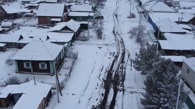 Siberia: A man shovels snow in the Siberian town of Tara in the Omsk region. (Reuters)