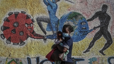 Kenya: A woman and child walk past an informational mural portraying the global battle against the coronavirus, on a street in Kericho, Kenya. (AP) Kenya: A woman and child walk past an informational mural portraying the global battle against the coronavirus, on a street in Kericho, Kenya. (AP)