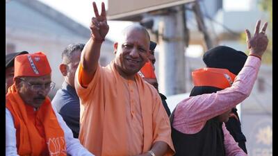 UP chief minister Yogi Adityanath shows victory signs during a roadshow for the Gujarat assembly elections, in Godhra, Panchmahal, on Tuesday. (ANI Photo) UP chief minister Yogi Adityanath shows victory signs during a roadshow for the Gujarat assembly elections, in Godhra, Panchmahal, on Tuesday. (ANI Photo)