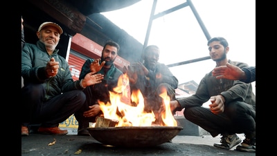 People warming themselves around a bonfire in Srinagar on a chilly Tuesday morning. (ANI photo)