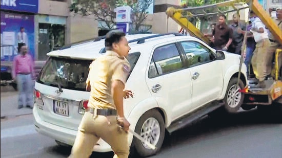 Hyderabad, Nov 29 (ANI): Police personnel drag away the car of YSR Telangana Party chief Sharmila Reddy with the help of a crane as she sits inside it to protest against State Chief Minister K Chandrashekhar Rao, in Hyderabad on Tuesday. (ANI Photo) (ANI)