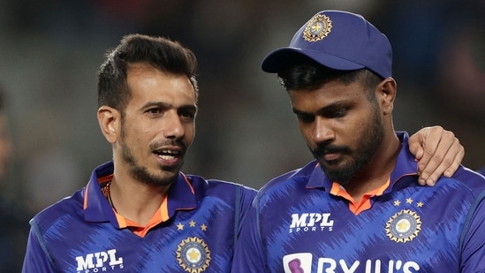 India's Yuzvendra Chahal (L) consoles Sanju Samson after their defeat during the first one-day international cricket match between New Zealand and India at Eden Park in Auckland on November 25, 2022. (Photo by DAVID ROWLAND / AFP)(AFP)