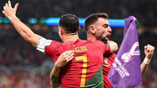 Portugal's forward Cristiano Ronaldo (L) celebrates scoring his team's first goal with Portugal's midfielder Bruno Fernandes during the Qatar 2022 World Cup Group H football match between Portugal and Uruguay at the Lusail Stadium in Lusail.(AFP)