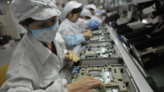 Chinese workers working in the Foxconn factory, the world's largest iPhone factory.(AFP)