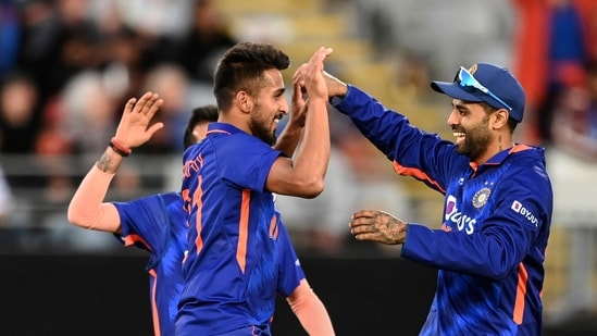 India's Umran Malik, left, celebrates with teammates after taking the wicket of New Zealand's Daryl Mitchell during their one day international cricket match in Auckland, New Zealand, Friday, Nov. 25, 2022. (Andrew Cornaga/Photosport via AP)(AP)