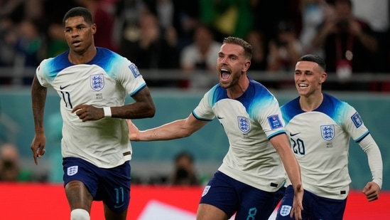 England's Marcus Rashford, left, celebrates with teammates after scoring the opening goal during the FIFA World Cup group B match between England and Wales, at the Ahmad Bin Ali Stadium in Al Rayyan.(AP)