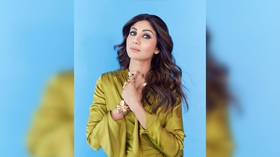 The ever-so-stylish Shilpa Shetty once again made headlines for her eye-grabbing wardrobe choice. She was recently spotted stepping out in a comfy yet fancy outfit. She donned a satin green wrap asymmetrical dress which she paired with white sneakers.(Instagram/@theshilpashetty)