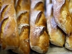 UNESCO World Heritage Status: A baker takes out of the oven a tray of baguettes at "Armand" bakery in Nice, France, November 28, 2022.  REUTERS/Eric Gaillard
