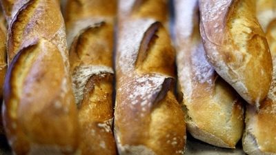 UNESCO World Heritage Status: A baker takes out of the oven a tray of baguettes at "Armand" bakery in Nice, France, November 28, 2022.  REUTERS/Eric Gaillard (Reuters)