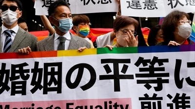 Japan Same-Sex Marriage: Plaintiffs hold placards outside the court. (Reuters)