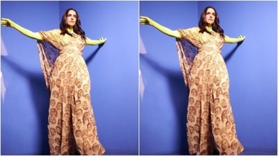 Neha decked up in a beige satin jumpsuit with faces printed on it. Neha teamed it with a neon yellow turtle neck top. (Instagram/@nehadhupia) Neha decked up in a beige satin jumpsuit with faces printed on it. Neha teamed it with a neon yellow turtle neck top. (Instagram/@nehadhupia)