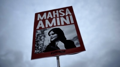 Iran Anti-Hijab Protests: A woman holds a placard with a picture of Iranian woman Mahsa Amini during a protest against her death. (AP file)