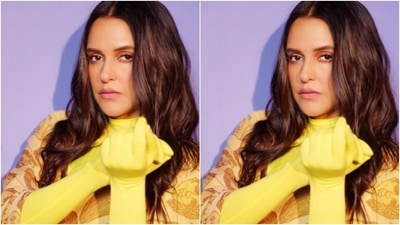 Neha further accessorsied her attire with pastel pink pumps as she posed against a bright blue backdrop. (Instagram/@nehadhupia) Neha further accessorsied her attire with pastel pink pumps as she posed against a bright blue backdrop. (Instagram/@nehadhupia)